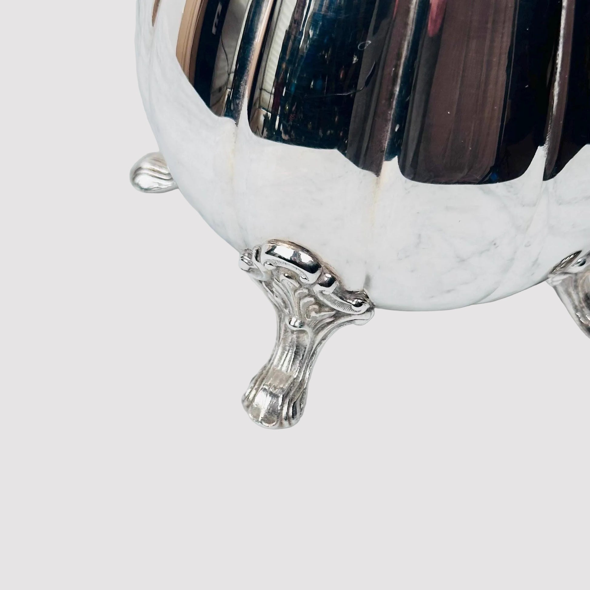 Silver footed bowl on a marble surface