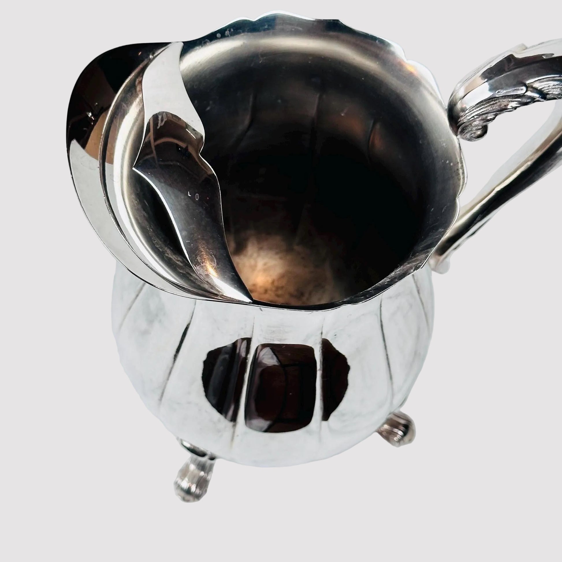 Metallic pitcher on a marble surface