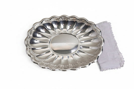 Silver decorative plate on a beige background