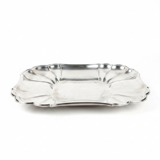 Silver tray on a marble surface with a light gray background