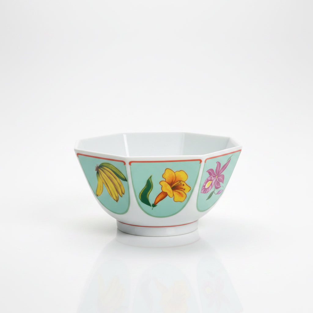 Decorative bowl with floral and banana design on a white surface