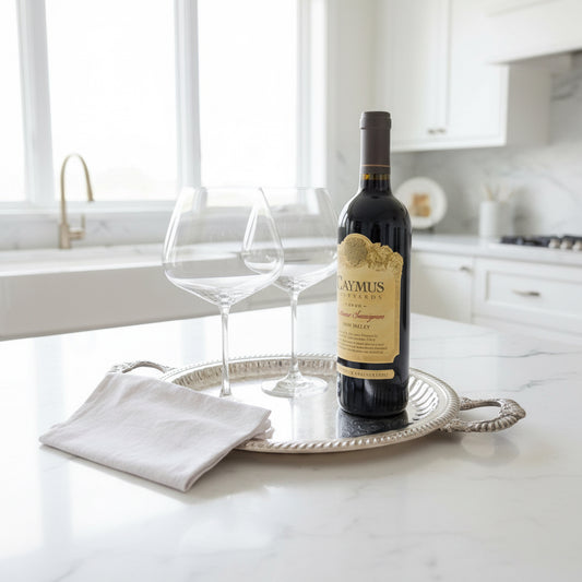 Wine bottle and glasses on a silver tray with a white background