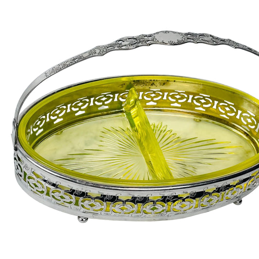 Decorative silver bowl with a yellow candle on a marble surface